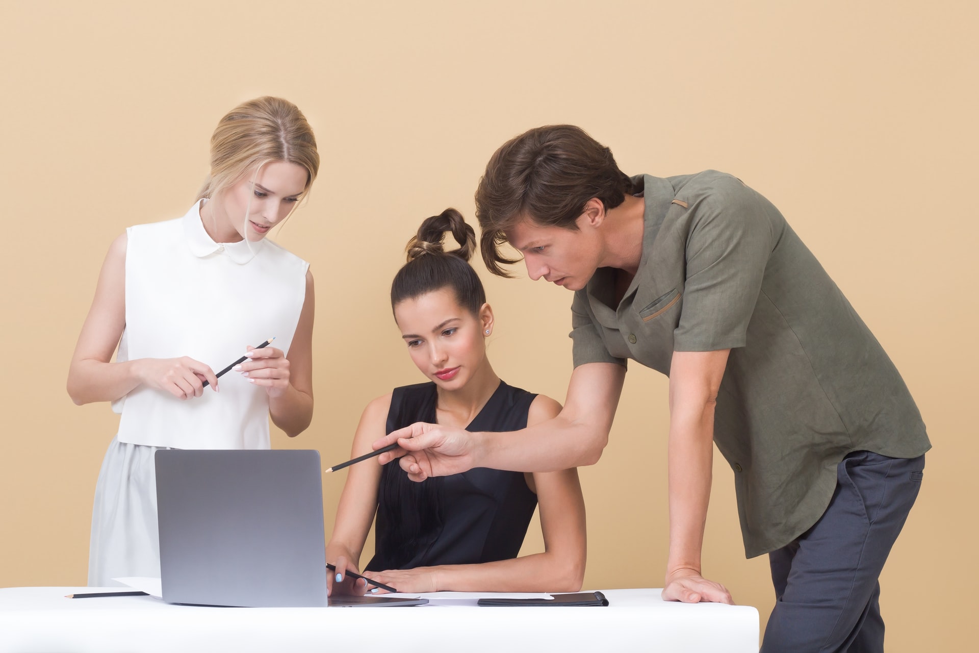 people looking at laptop