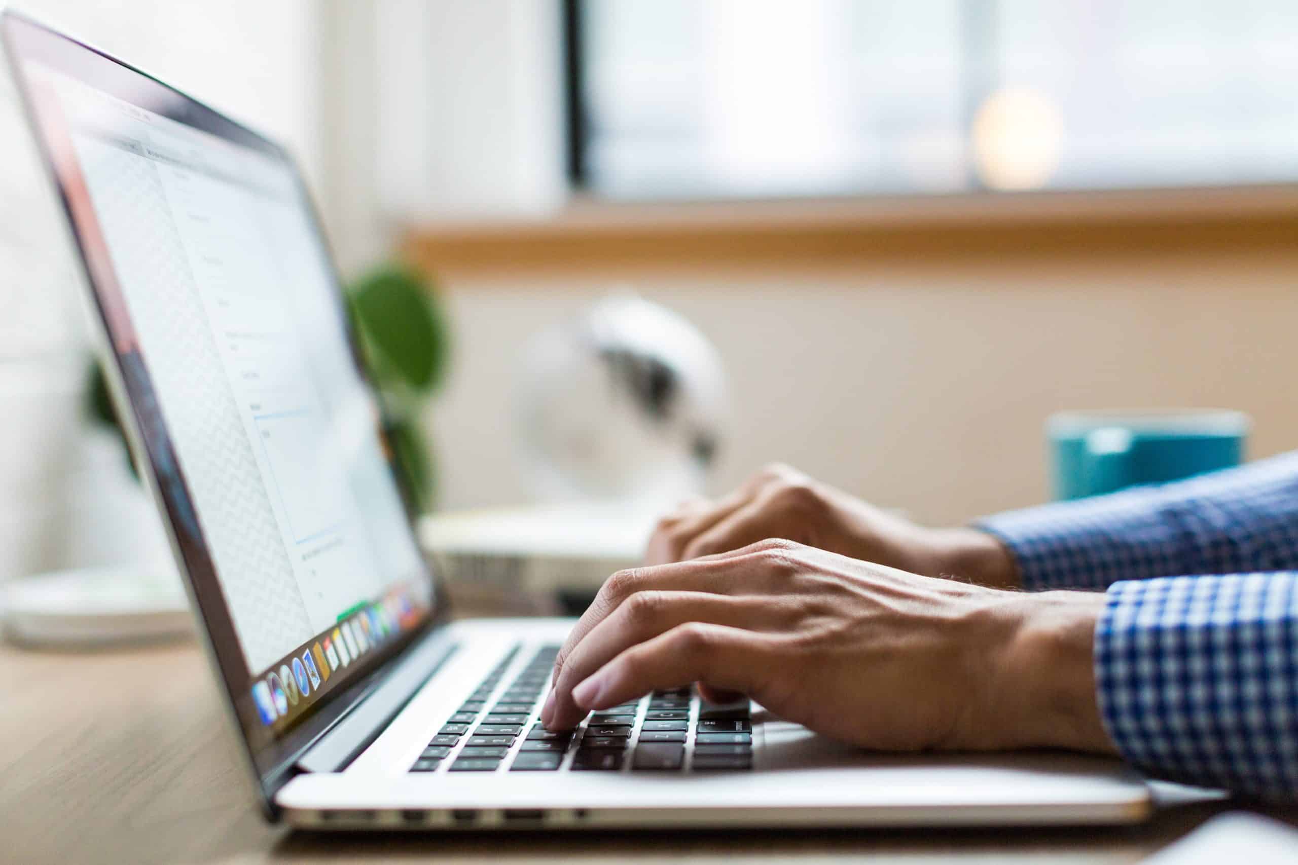 person composing an email on their computer