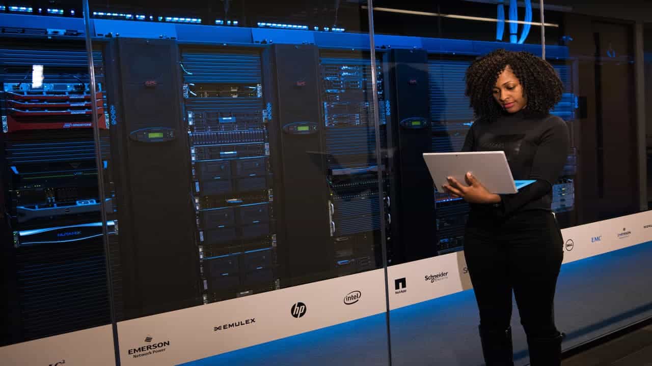 woman with a laptop at some web servers